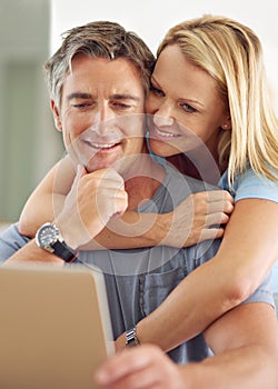 Take a look at this. a happy mature couple using a laptop at home.