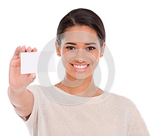 Take a look. Portrait of an attractive young woman holding a blank business card isolated on white.