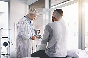 Take a look at this...a senior doctor giving his male patient a thorough checkup during his consultation.