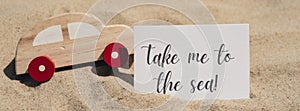 TAKE ME TO THE SEA text on paper greeting card and car summer vacation decor. Sandy beach sun coast. Holiday concept