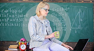 Take a minute break. Working conditions which prospective teachers must consider. Woman calm teacher holds mug drink sit