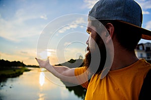 Take moment to admire sunset nature beauty. River sun reflection. Man in cap enjoy sunset while stand on bridge. Enjoy