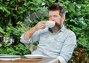 Take moment to enjoy life. Man bearded hipster make pause for drink coffee and relax while sit with laptop. Guy drinks