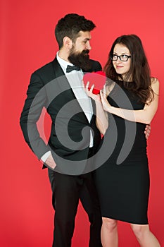Take my heart. one heart for two. sexy woman and mature man with beard. couple in love. formal couple. Love relationship
