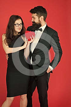 Take my heart. one heart for two. sexy woman and mature man with beard. couple in love. formal couple. Love relationship