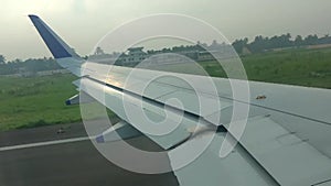 Take off footage airplane flight. wing of an airplane flying above the white clouds and blue sky