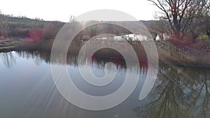 Take off from lakeshore on a sunny day, near a small fishing lake in Sarisap, Hungary