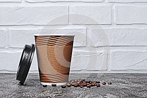 Take-out blank paper brown coffee cup with black cover, craft cup holder and beans