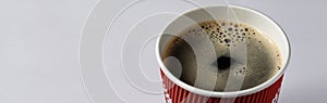 Take-out coffee in opened thermo cup against white.