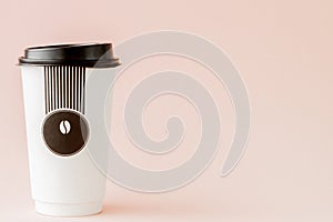 Take-out coffee in thermo cup on a pink background, Copy space