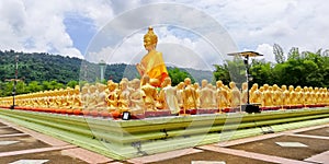 Take photo of  Buddha statue sitting   image of 1250 monks chant around the Buddha image at  Phuttha Utthayan Makha Bucha Anusorn