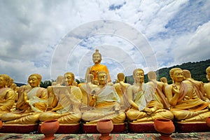 Take photo of  Buddha statue sitting   image of 1250 monks chant around the Buddha image at  Phuttha Utthayan Makha Bucha Anusorn