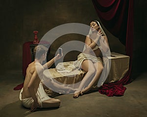 Modern remake of classical artwork with modern tech theme - young medieval couple on dark background