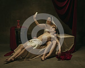 Modern remake of classical artwork with modern tech theme - young medieval couple on dark background photo