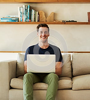 Take some time to check out my blog. Portrait of a handsome young man using his laptop while sitting on the sofa at home