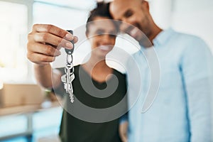 Take the step towards a fresh start. Portrait of a young couple holding the keys to their new home.