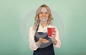 take it. take away beverage. cheerful girl drinking tea. woman in apron with plastic cup