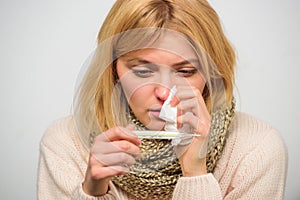 Take temperature and assess symptoms. Measure temperature. Woman feels badly ill sneezing. Girl in scarf hold