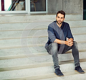 Take the time to appreciate the journey to success. Full length shot of a handsome young businessman sitting alone on a