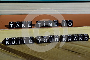 Take time to build your brand on wooden blocks. Motivation and inspiration concept