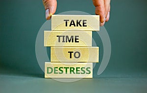 Take time to destress symbol. Concept words Take time to destress on wooden blocks. Beautiful grey table grey background.