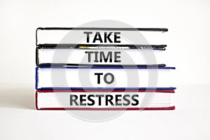 Take time to restress symbol. Concept words Take time to restress on books on a beautiful white table white background.