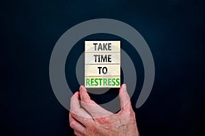 Take time to restress symbol. Concept words Take time to restress on wooden blocks. Beautiful black table black background.