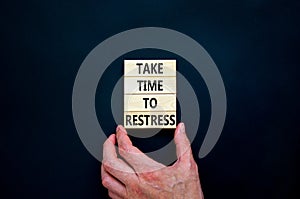 Take time to restress symbol. Concept words Take time to restress on wooden blocks. Beautiful black table black background.