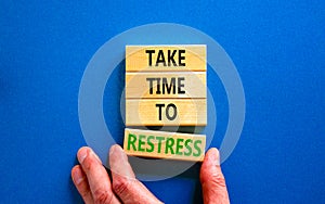 Take time to restress symbol. Concept words Take time to restress on wooden blocks. Beautiful blue table blue background.