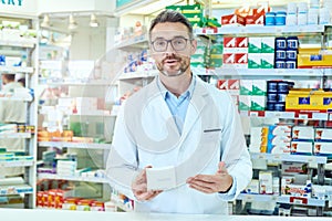 Take these, trust me. Cropped portrait of a handsome mature male pharmacist working in a pharmacy.