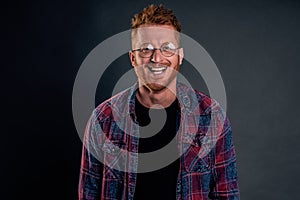 Take this ugly thing away from me. Displeased intense redhead mature guy in glasses and checkered shirt, turning away