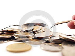 Take up coins by spoon, thai baht money