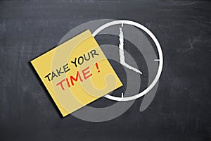 Take your time concept with alarm clock on school board