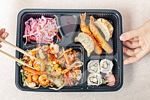 Bento lunch plastic box with chopsticks. Japanese and asian cuisine