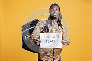 Takeaway employee holding job offer sign