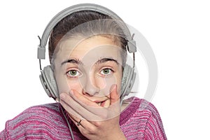 Taken aback teenage girl with headphones photo