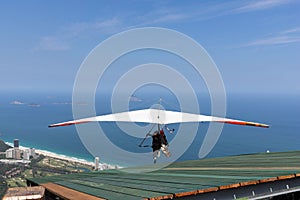 Takeoff of a hang glider flight to fly over the beach