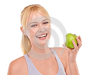 She always takes the healthy option. Studio portrait of an attractive young woman eating an apple isolated on white.