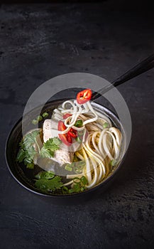 Taking asian soup by chopsticks with copy space