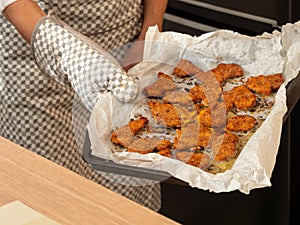 Taking baked breaded cutlets