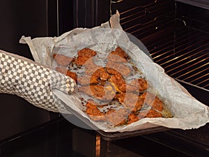 Taking baked breaded cutlets