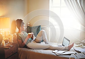 Taking a break from her studies. Full length shot of a young female student studying at home.