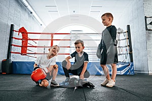 Taking a break, resting. Boys training boxing in the gym together