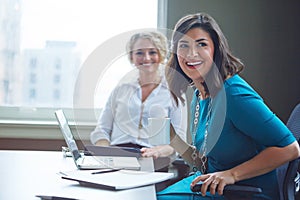 Taking on business with a can do attitude. two businesswomen having a meeting together in an office.