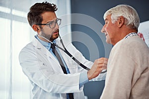 Taking care of the elderly. a doctor examining a senior patient with a stethoscope in a clinic.