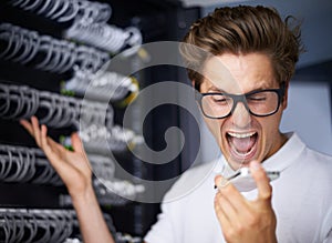 Taking care of your network needs. An angry technician screaming at his phone.
