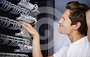 Taking care of your network needs. A computer technician fixing a server.