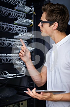 Taking care of your network needs. A computer technician fixing a server.