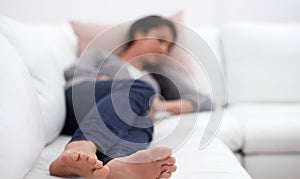 Taking a cat nap. A young woman taking a nap on her sofa.