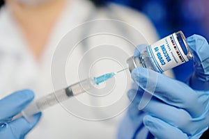 Taking COVID-19 vaccine into syringe. Doctors create invent coronavirus vaccine.